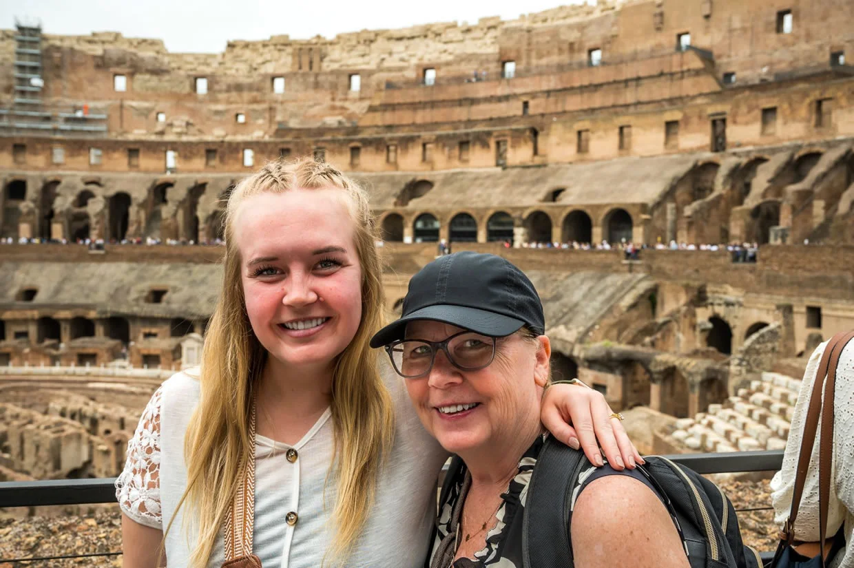 Two LSC students posing for a photo in the Colosseum in Italy while studying abroad.